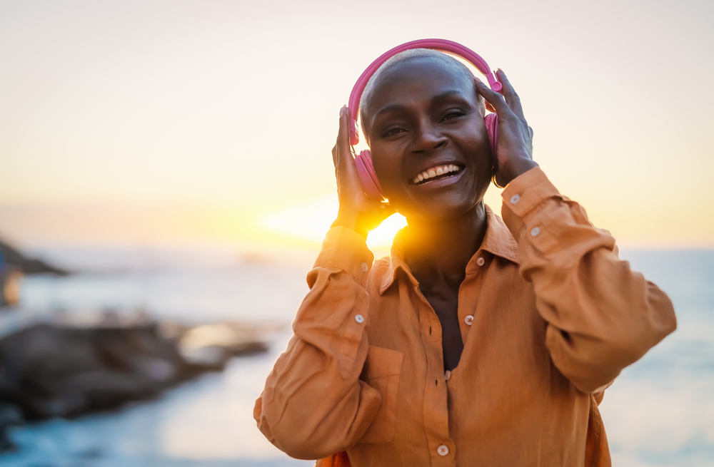 Happy,Senior,African,Woman,Enjoying,Listening,Music,In,Front,Of